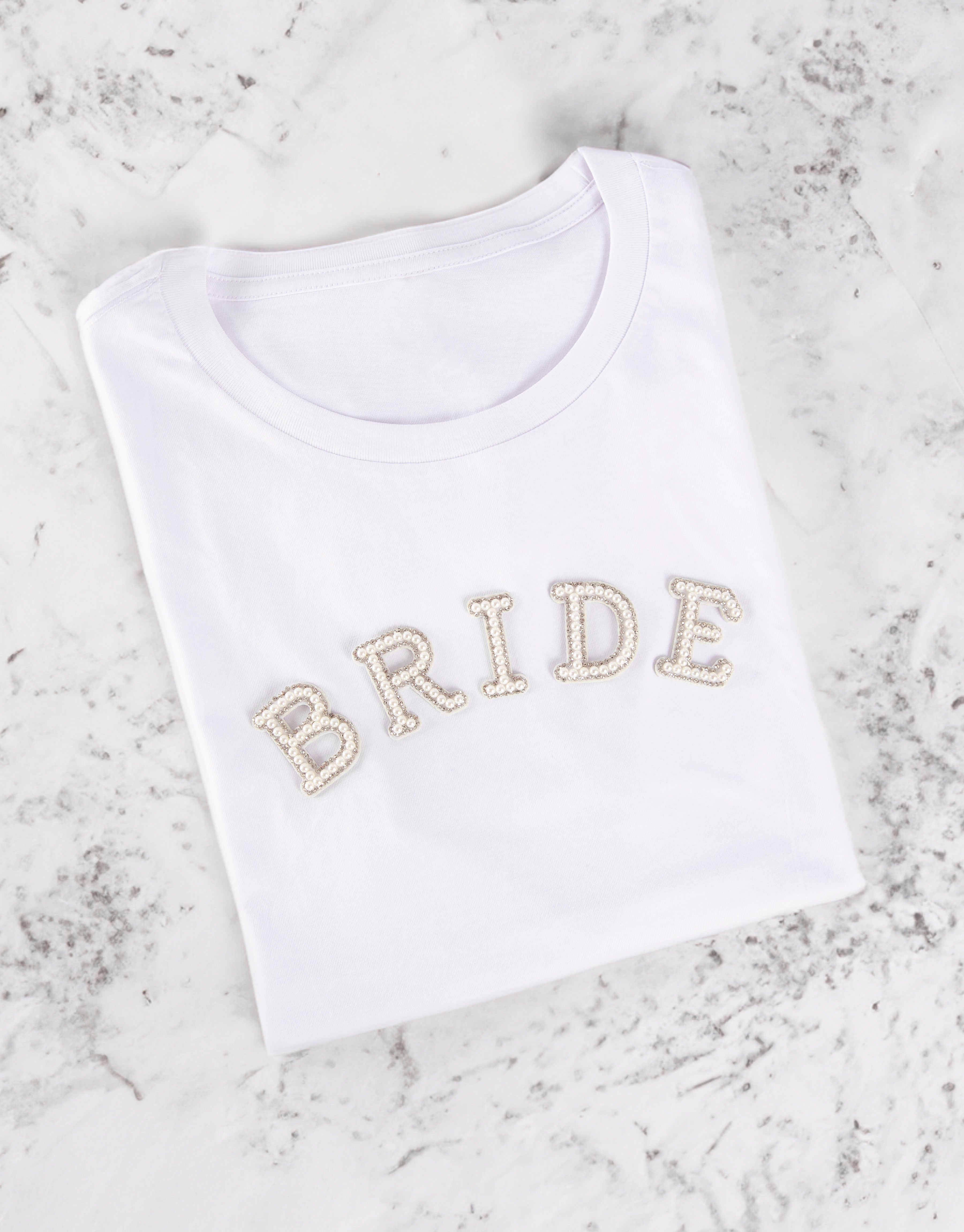 BRIDE iron-on patch on white Tshirt