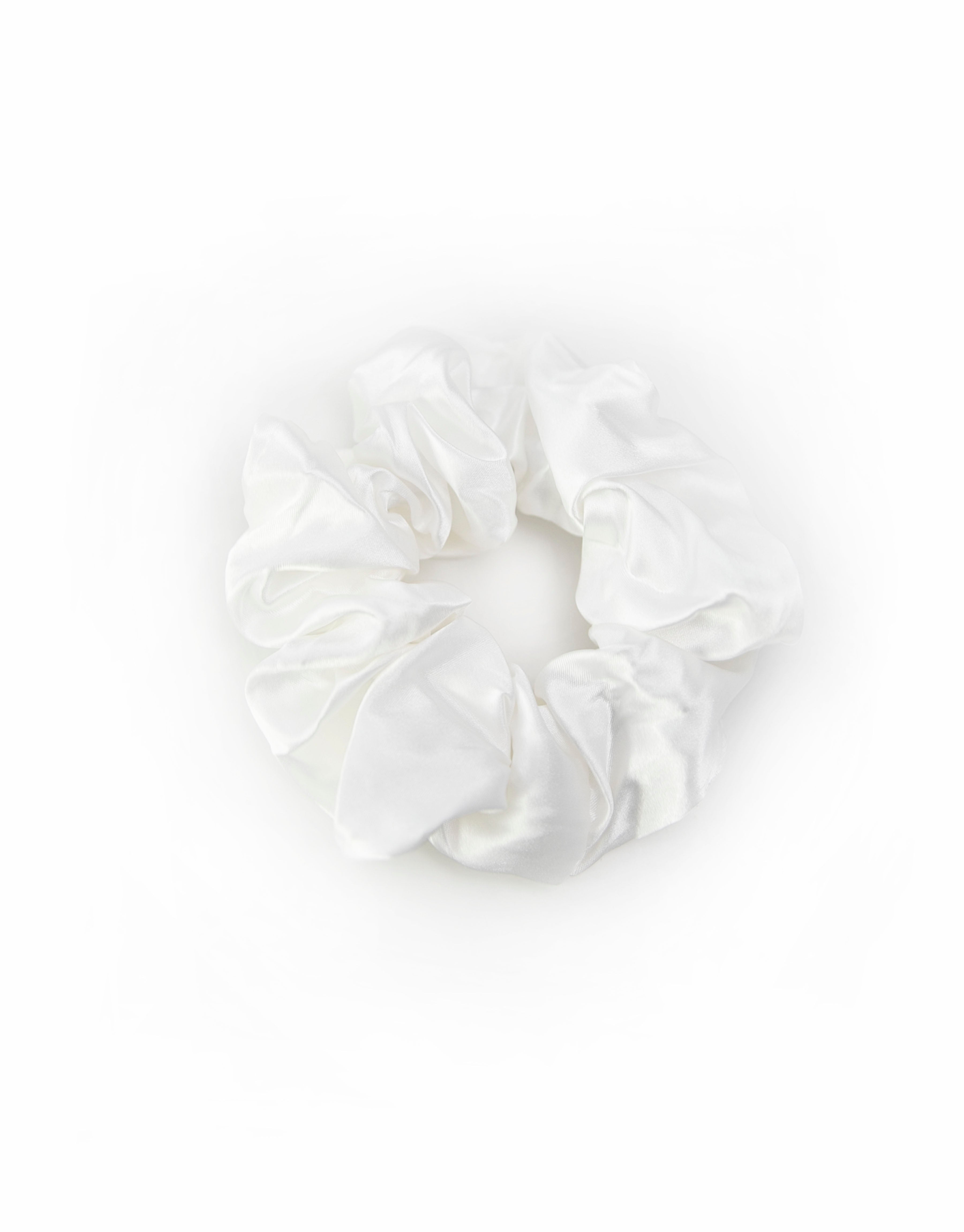 Satin scrunchies in white, soft and silky with a gentle sheen, perfect for adding a touch of elegance to hairstyles.
