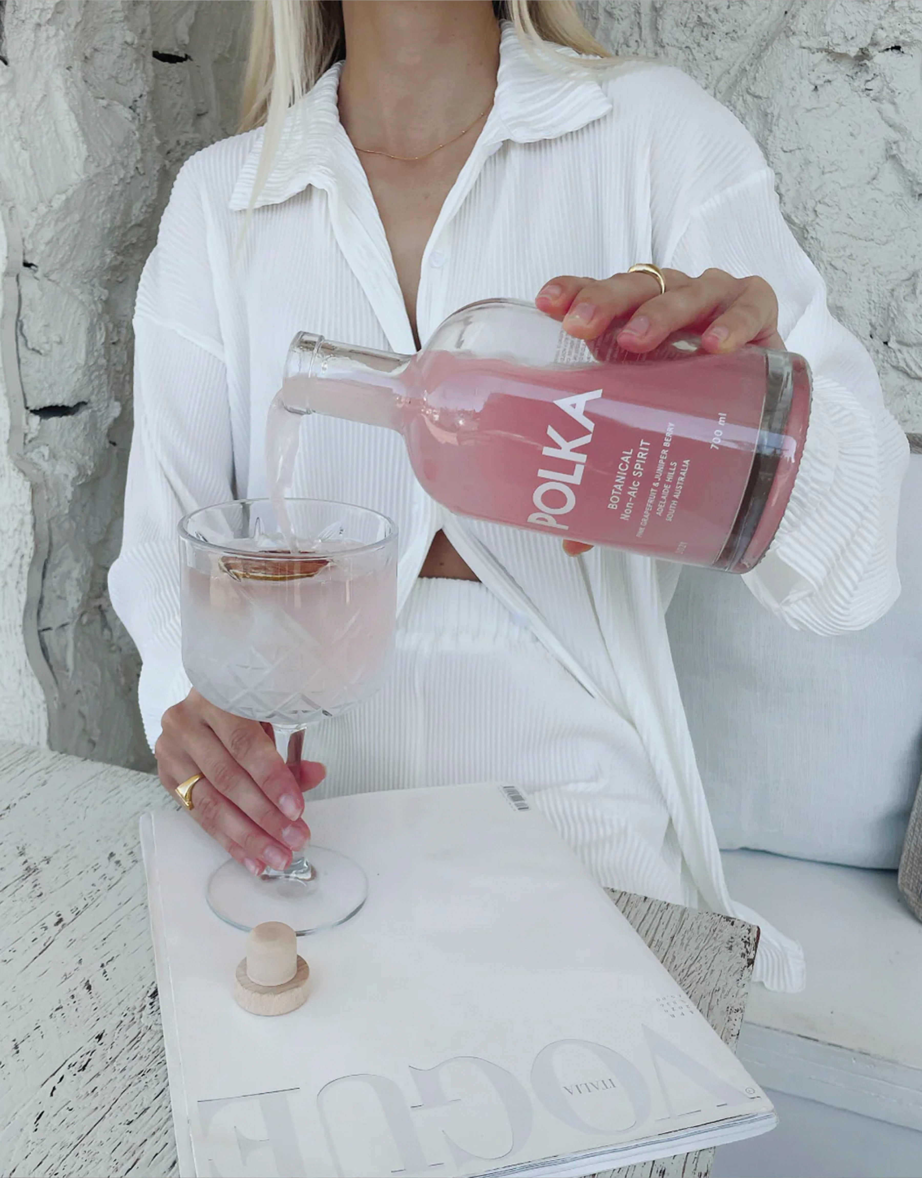 Botanical spirit being poured into a glass