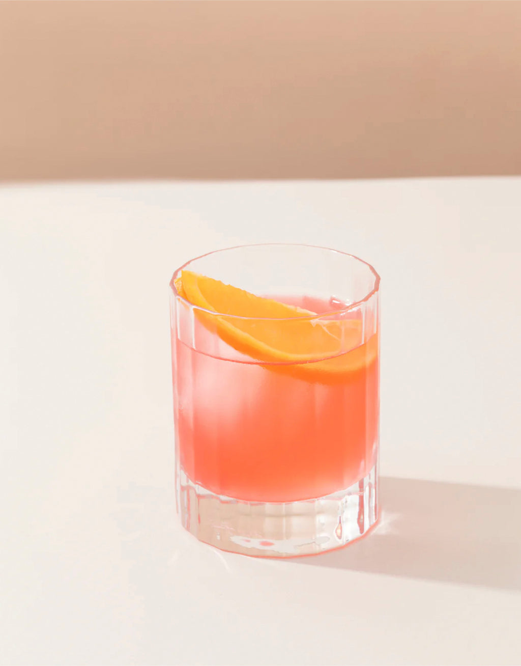 Glass of Aperitif garnished with a slice of orange.