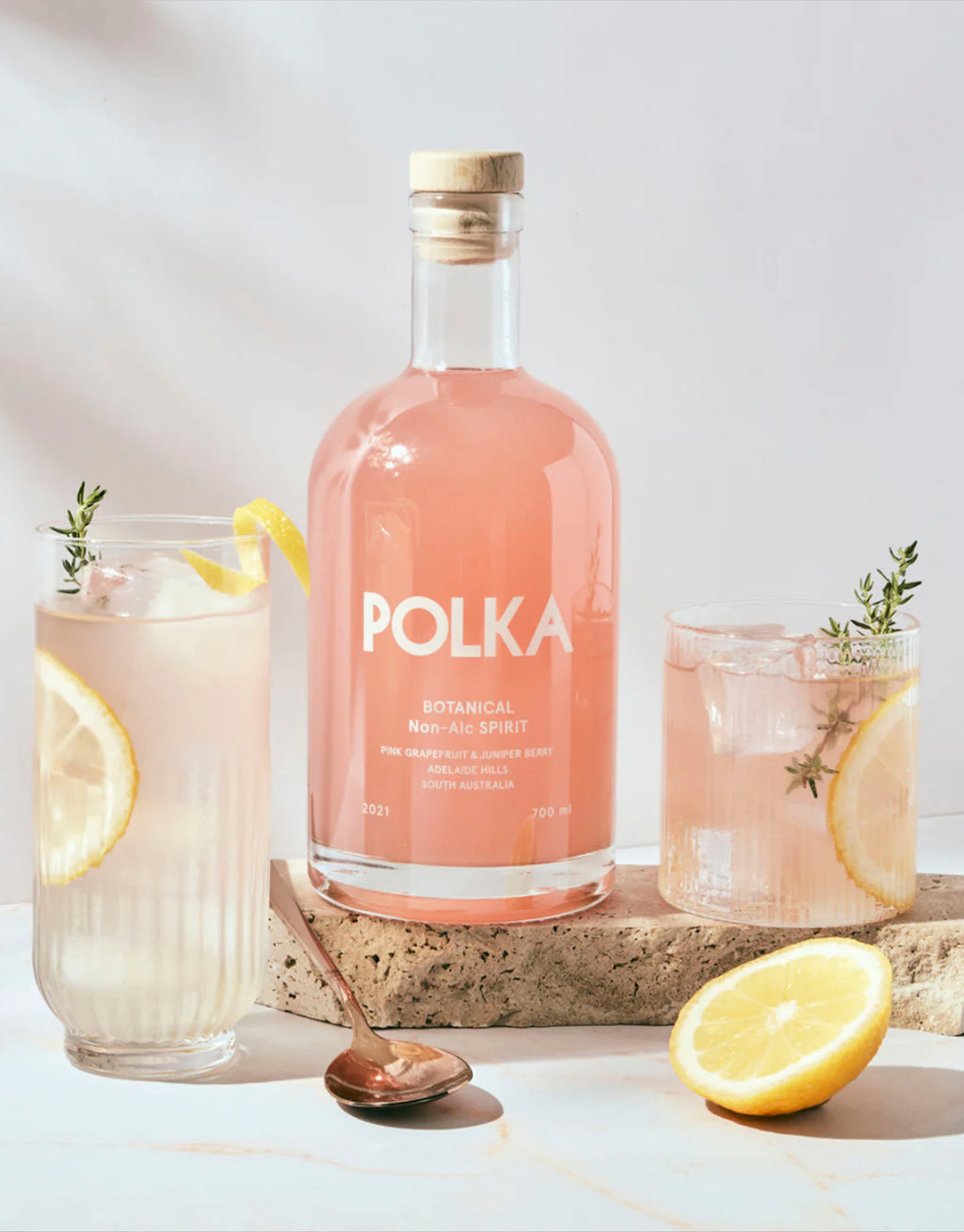 Botanical spirit garnished with fresh lemon slices.