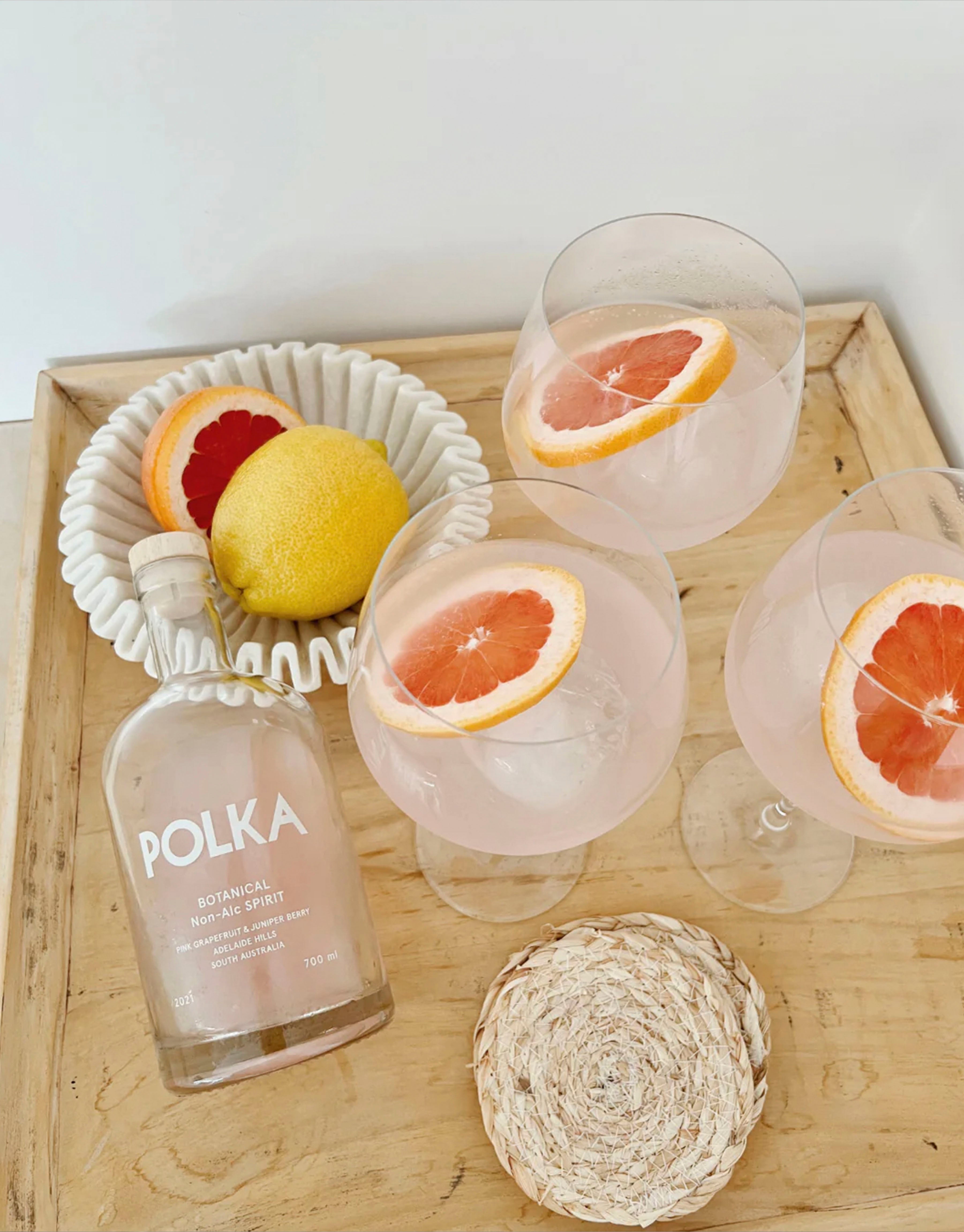 Botanical spirit garnished with fresh blood orange slices.